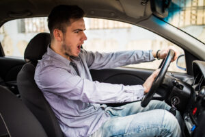 traffic problems nice emotional man giving signal while driving car