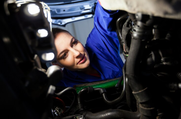 Free Photo Free photo female mechanic examining car engine
