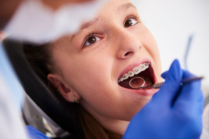 Free Photo Free photo girl with braces during a routine dental examination